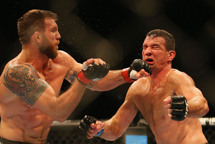 Ryan Bader (left) lands a hard left to the chin of Anthony Perosh during their UFC light heavyweight bout in Brisbane.