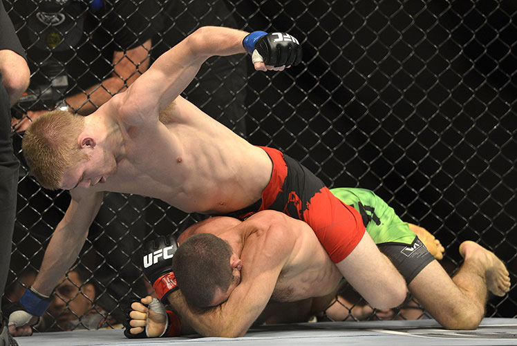 Justin Scoggins (top) lands lefts and rights on Australia's Richie Vaculik.