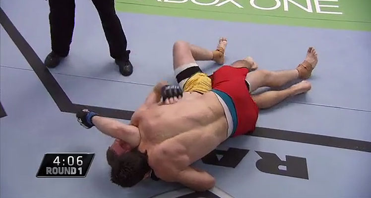 Sheldon Westcott (red trunks) secures the head and arm triangle choke, forcing Dan Kelly to tap.