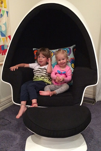 Zac and Lola relax in a replica Eero Aarnio ball chair.