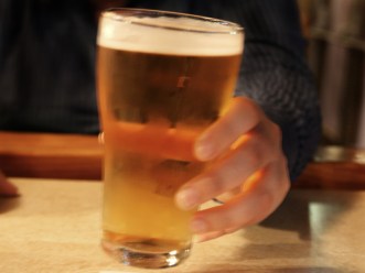 File photo of a person holding a glass of beer