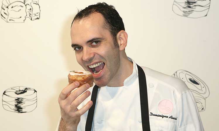 Dominique Ansel bites into his creation. 