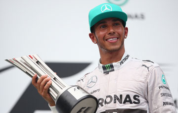 Lewis Hamilton with the spoils of victory. Photo: Getty