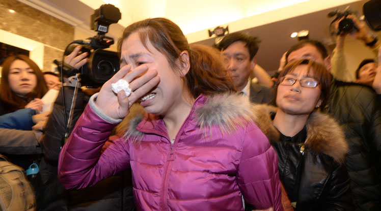 A weeping relative after news of the disaster emerges.