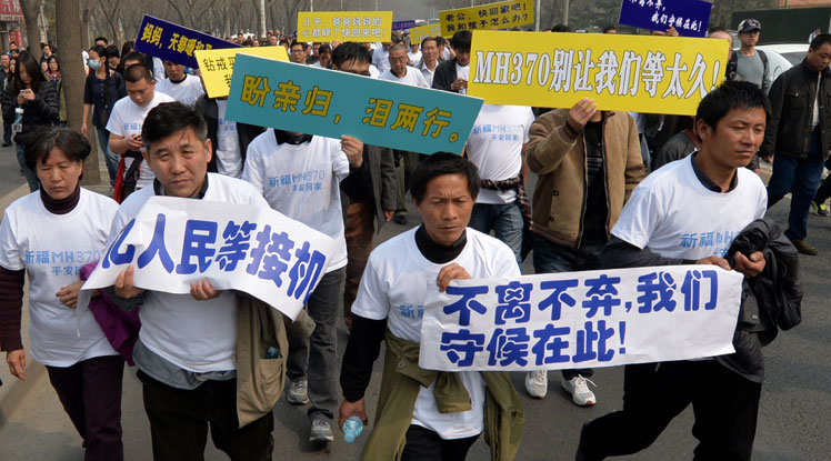 Relatives stage a protest outside the Malaysian embassy in Beijing.