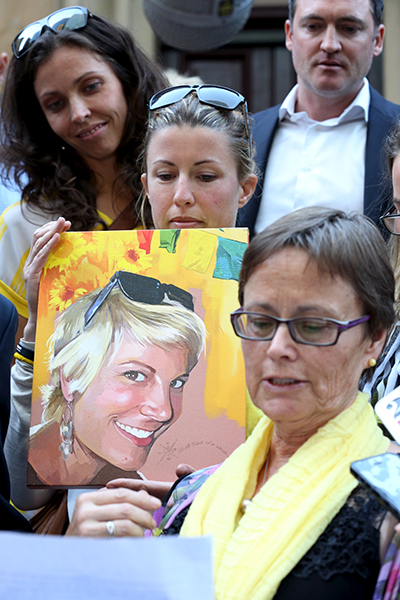 An emotional Kathy Yeo with a portrait of her daughter. 