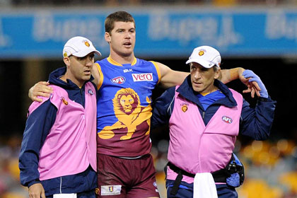 Being helped off the ground for one last time after receiving a knock to the head earlier this month. Photo: Getty