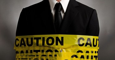 Man wrapped in tape saying caution