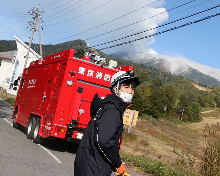 Rescue team workers rush to Mt. Ontake. Picture: Getty