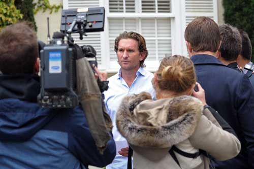 James Hird reads his statement outside his home on Thursday morning. Photo: AAP