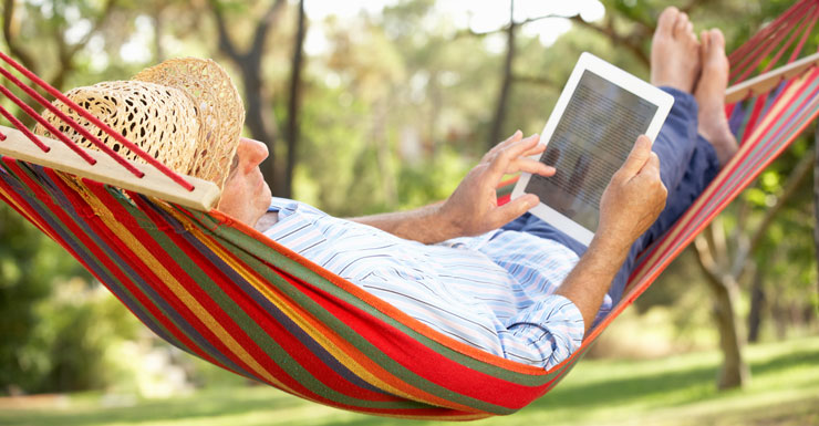 man reclines in hammock