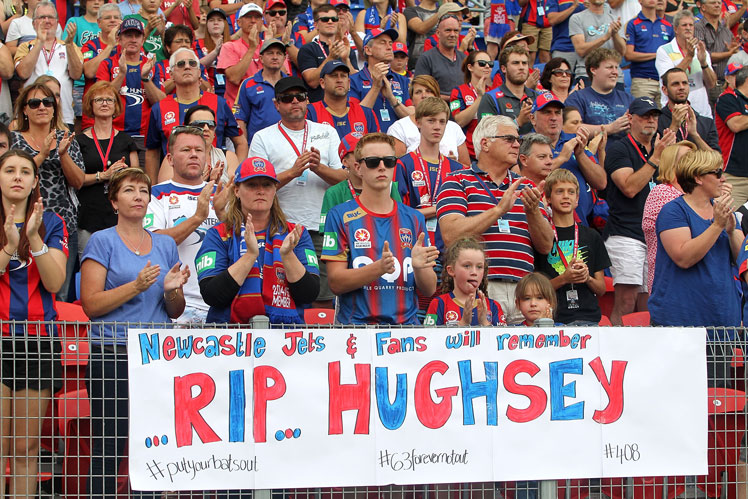Newcastle applaud for Phillip Hughes at the 63 minute mark of the match against Central Coast Mariners. Photo: Getty