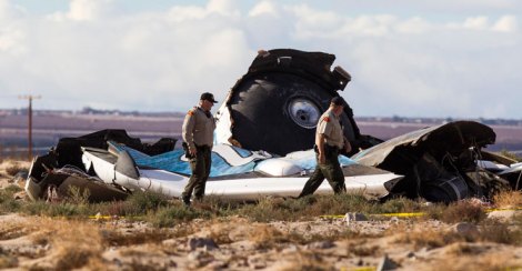 Law enforcement officials take a closer look at the wreckage near the site where a Virgin Galactic space tourism rocket, SpaceShipTwo, exploded and crashed.