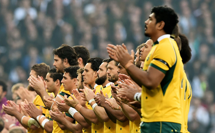 The Wallabies observe a minute's applause for Hughes at Twickenham. Photo: Getty