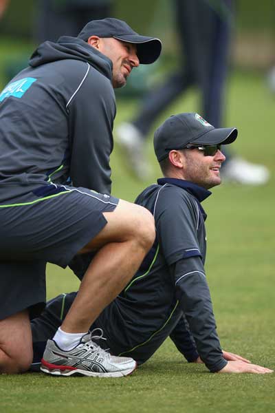 Michael Clarke performs his now-familiar cobra stretch with the aid of Alex Kountouris. Photo: Getty