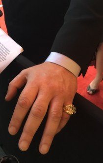 Crowe shows off his premiership ring at 'The Water Diviner' premiere in Melbourne.