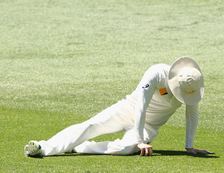 Michael Clarke goes down with his right hamstring injury yesterday. Photo: Getty