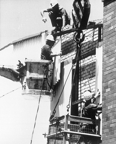 Rescue workers check structural damage to a building. Photo: AAP