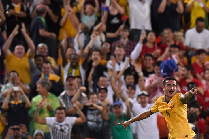 Cahill wheels away to celebrate his second strike as Brisbane's crowd goes crazy. Photo: Getty