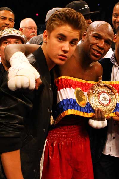 Floyd Mayweather celebrates another win with a young fan. Photo: Getty