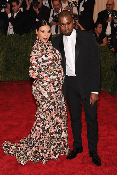 A heavily pregnant Kardashian somehow loses her hand in the floral arrangement she is wearing at the Met Gala Ball in 2013. Photo: Getty