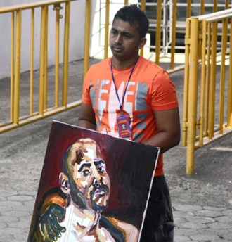 Chintu Sukumaran with a painting by brother Myuran. 