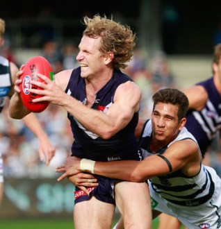 Docker's David Mundy breaks from a tackle.  