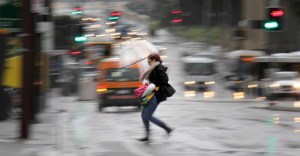 A woman races for cover in Brisbane.