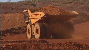 The mining downturn is weighing on investment, even as the production boom boosts exports.