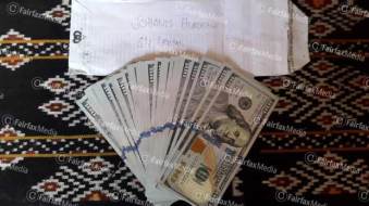 Cash which Indonesian Police took from people smugglers. They say it came from Australian official 'Agus'. Photo: Fairfax Media