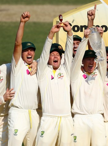 The captain (centre) lifts the Ashes urn. Photo: Getty