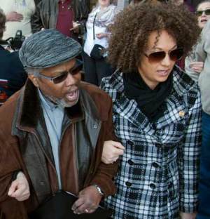 Rachel Dolezal (R) at a race rally in Spokane singing 'We Shall Overcome' with fellow campaigner Charles Thornton. Photo: AAP