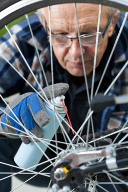 A man cleans his bike. Photo: Shutterstock