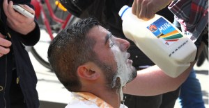 A protester gets his eyes washes out after being hit with police pepper spray during a protest in Melbourne.