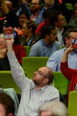 Delegates register votes by raising their hands. Photo: AAP