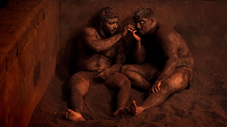 Kushti, Indian Wrestling: "At the end of a workout, wrestlers rest with their heads against the arena. Photo: Alain Schroeder - National Geographic Traveler Photo Contest