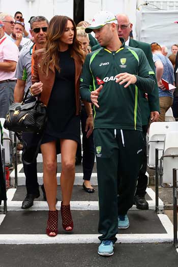 Michael and Kyly Clarke walk onto the field of play after Australia's defeat. Photo: Getty