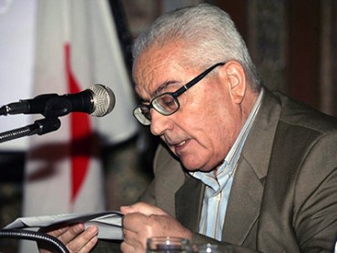 In this undated photo released Tuesday, Aug. 18, 2015 by the Syrian official news agency SANA, one of Syria's most prominent antiquities scholars, Khaled al-Asaad, speaks in Syria. Islamic State militants beheaded al-Asaad in the ancient town of Palmyra, Syria, then strapped his body to one of the town's Roman columns, Syrian state media and an activist group said Wednesday. The killing of 81-year-old al-Asaad was the latest atrocity perpetrated by the militant group, which has captured a third of both Syria and Iraq. (SANA via AP)