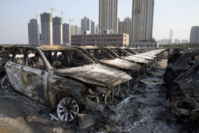 Charred remains of new cars are after an explosion tore through the parking lot.