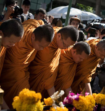 Buddhist monks chanted as they led the morning ceremony that drew together devotees.