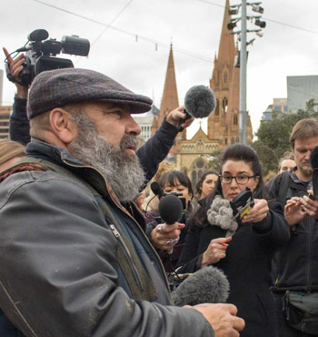 Richard Frankland speaks to the media after a war dance flash mob in Federation Square.