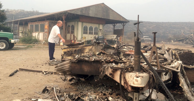 Steve Surgeon surveys the ruins after he lost everything he owned except his home in a wildfire on the outskirts of Okanogan. Photo: AAP