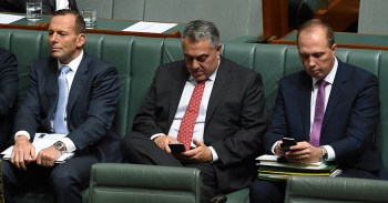 Australian Prime Minister Tony Abbott (left), Treasurer Joe Hockey (centre) and Minister for Immigration Peter Dutton during a division in the House of Representatives Question Time at Parliament House in Canberra, Thursday, Aug. 13, 2015. (AAP Image/Mick Tsikas) NO ARCHIVING