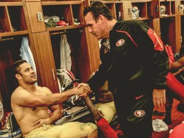 Hayne (left) is congratulated by 49ers head coach Jim Tomsula in the locker room. 