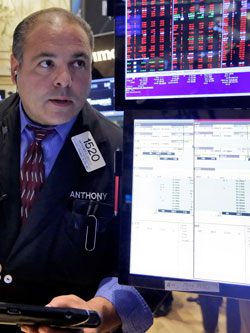 Trader Anthony Riccio was on the floor of the New York Stock Exchange as more signs of weakness in China's economy send global stock markets sharply lower. Photo: AAP