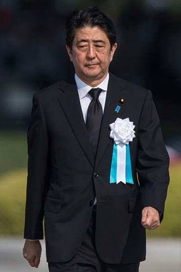 HIROSHIMA, JAPAN - AUGUST 06: Japanese Prime Minister Shinzo Abe walks to give a speech during the 70th anniversary ceremony of the atomic bombing of Hiroshima at the Hiroshima Peace Memorial Park on August 6, 2015 in Hiroshima, Japan. Japan marks the 70th anniversary of the first atomic bomb that was dropped by the United States on Hiroshima on August 6, 1945. The bomb instantly killed an estimated 70,000 people and thousands more in coming years from radiation effects. Three days later the United States dropped a second atomic bomb on Nagasaki which ended World War II. (Photo by Chris McGrath/Getty Images)
