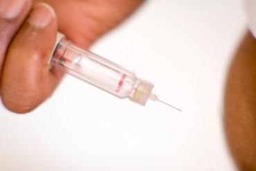 Man suffering from diabetes injecting insulin