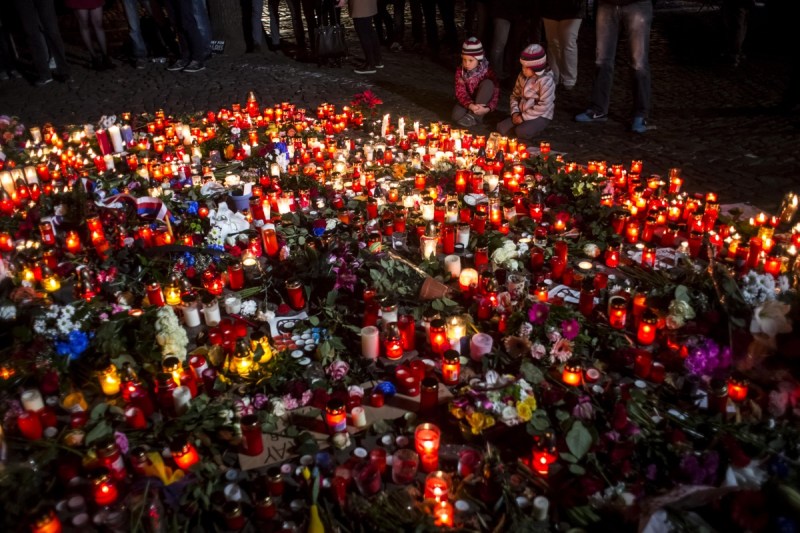 Candles and flowers at the fence of the French Embassy in Prague. Photo: Getty