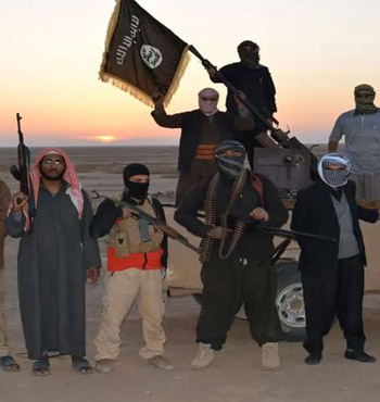 IS militants wave a flag in Iraq.