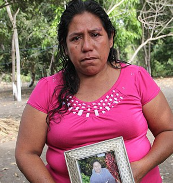 Roselia Diaz holds a picture of her dead son, Ezequiel.